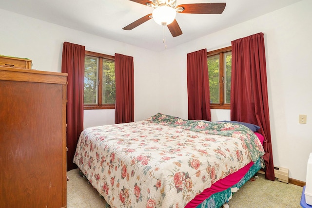 3765 Ryerson Rd, Twin Lake, MI 49457 - bedroom featuring carpet floors, multiple windows, baseboard heating, and ceiling fan