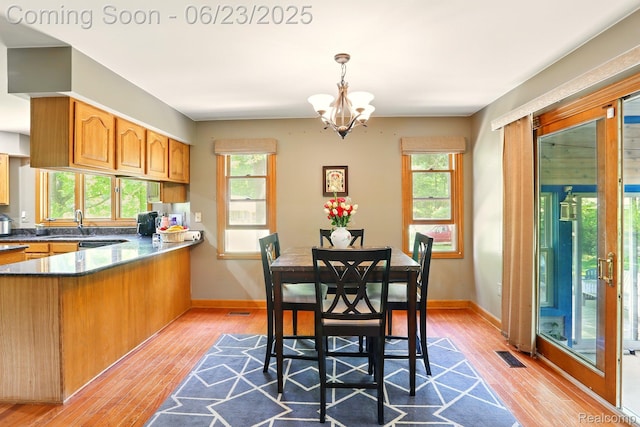 11970 Diamond Dr, Shelby Twp, MI 48315 - dining space with light wood-style floors and a chandelier