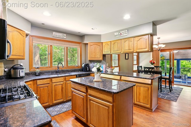 11970 Diamond Dr, Shelby Twp, MI 48315 - kitchen featuring a center island, light wood-style floors, dark stone counters, a chandelier, and a peninsula