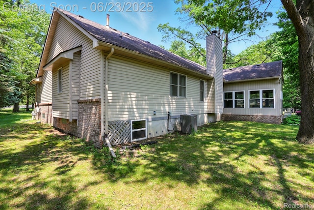 11970 Diamond Dr, Shelby Twp, MI 48315 - view of side of property with a chimney, a yard, and a shingled roof