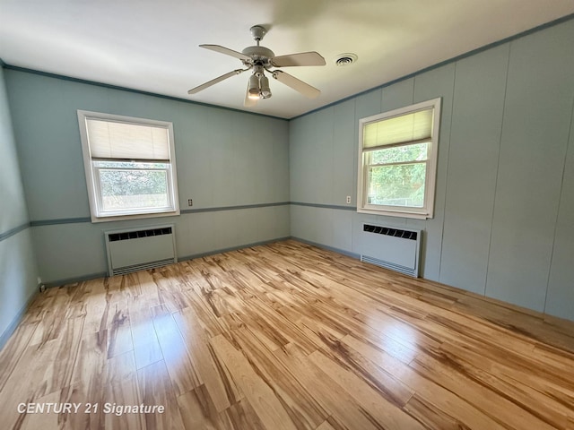1486 Lathrup Ave, Saginaw, MI 48638 - unfurnished room with radiator, healthy amount of natural light, wood finished floors, and a decorative wall