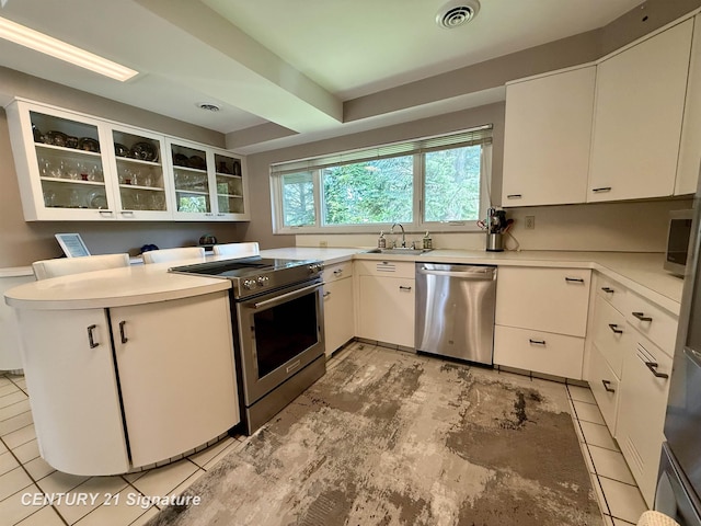 1486 Lathrup Ave, Saginaw, MI 48638 - kitchen featuring appliances with stainless steel finishes, a sink, glass insert cabinets, white cabinets, and light countertops