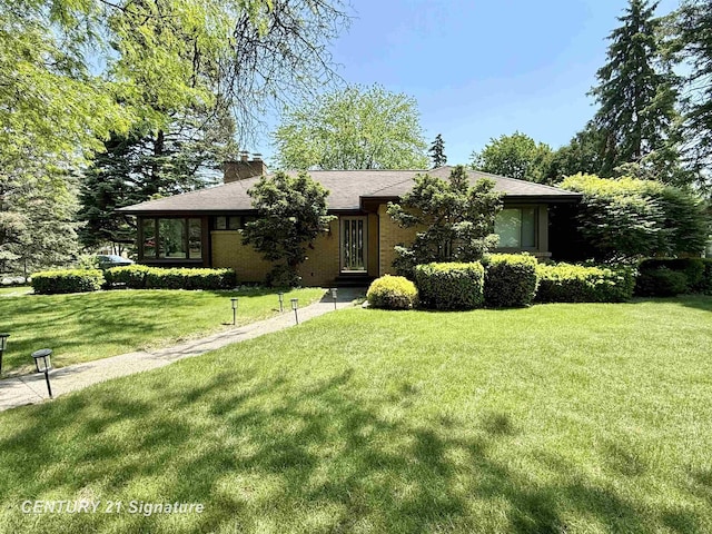 1486 Lathrup Ave, Saginaw, MI 48638 - view of front of home with a front lawn and a chimney