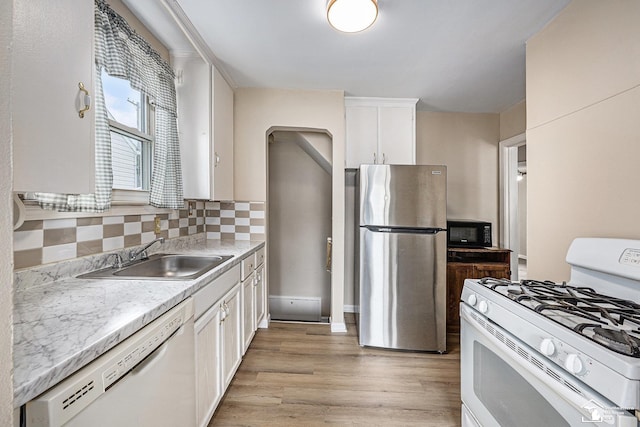 1989 Leblanc St, Lincoln Park, MI 48146 - kitchen with white appliances, a sink, white cabinetry, and decorative backsplash