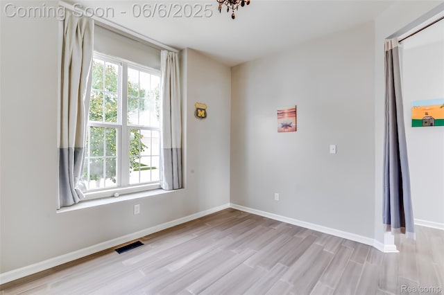 59625 Twin Pines Dr, New Hudson, MI 48165 - unfurnished room with wood finished floors and baseboards