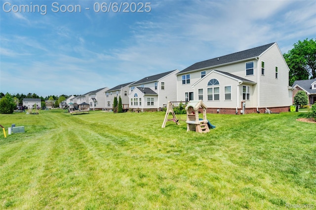 59625 Twin Pines Dr, New Hudson, MI 48165 - rear view of house with a lawn, a residential view, and a playground