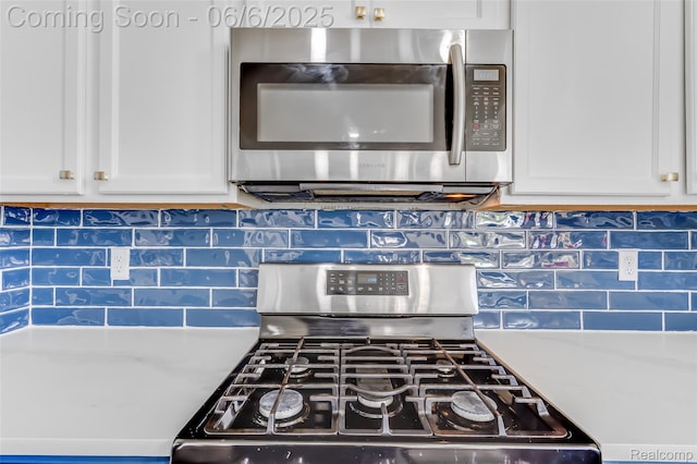 59625 Twin Pines Dr, New Hudson, MI 48165 - kitchen view of stainless steel appliances, white cabinetry, and backsplash