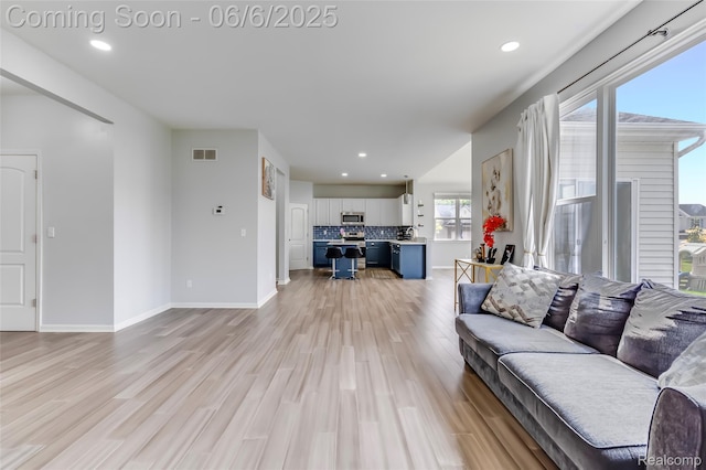 59625 Twin Pines Dr, New Hudson, MI 48165 - living area featuring light wood-style floors, baseboards, and recessed lighting