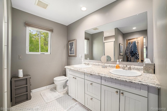 2816 W K Bar L Dr, Midland, MI 48640 - full bathroom with double vanity, toilet, baseboards, and a shower