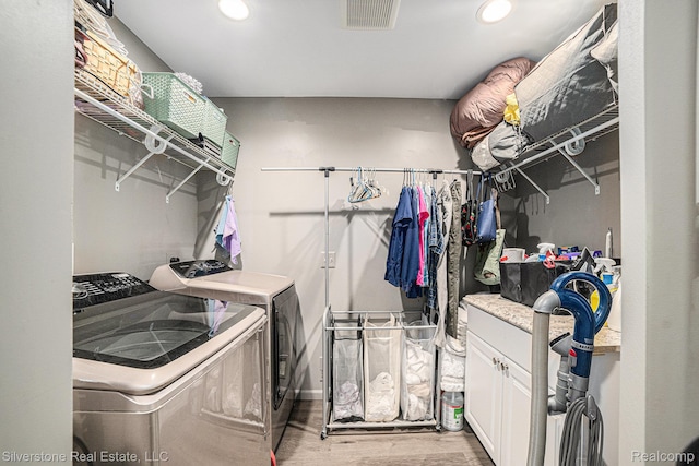 2816 W K Bar L Dr, Midland, MI 48640 - washroom with washing machine and clothes dryer, light wood-style flooring, and recessed lighting