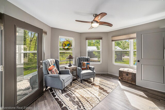 2816 W K Bar L Dr, Midland, MI 48640 - living area with wood finished floors, a ceiling fan, and baseboards