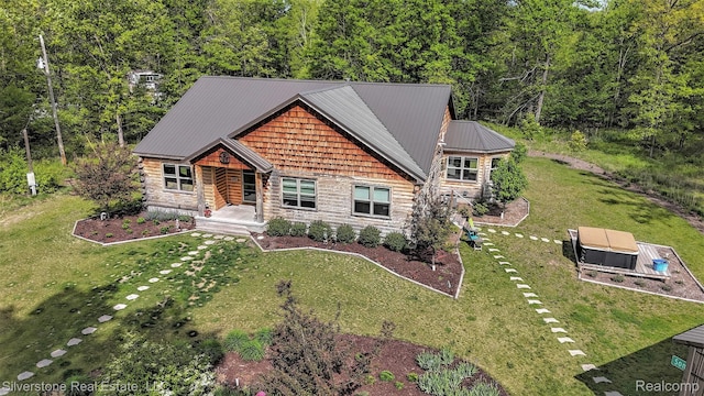 2816 W K Bar L Dr, Midland, MI 48640 - log home featuring a front yard, metal roof, and a view of trees