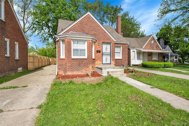18519 Morang Dr, Detroit, MI 48205 - bungalow featuring brick siding, a chimney, driveway, and roof with shingles