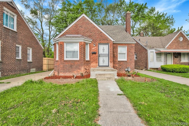 18519 Morang Dr, Detroit, MI 48205 - bungalow-style home with a chimney, brick siding, and a shingled roof