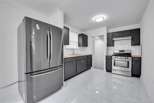 18519 Morang Dr, Detroit, MI 48205 - kitchen with appliances with stainless steel finishes, a sink, under cabinet range hood, backsplash, and light marble finish floors