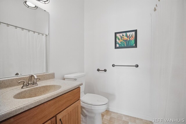 15021 S Star Lake Dr, Baldwin, MI 49304 - full bath with toilet, vanity, and baseboards
