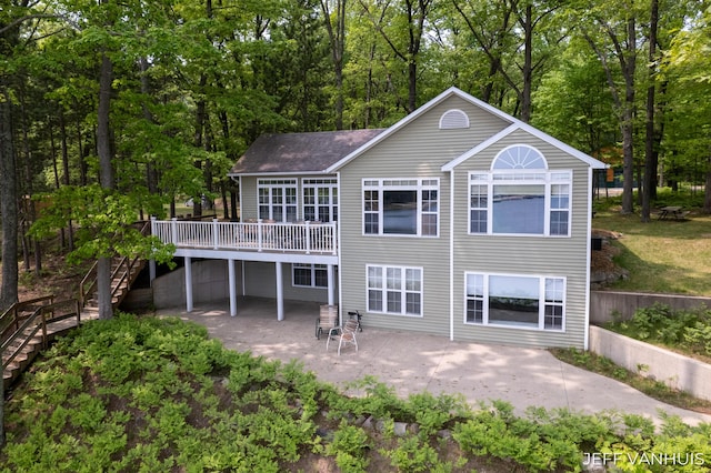 15021 S Star Lake Dr, Baldwin, MI 49304 - rear view of property featuring stairway, a wooden deck, a patio, and roof with shingles