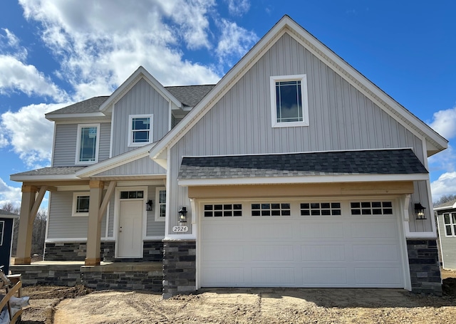 2924 Sheridan Cir Unit 57, Jackson, MI 49201 - craftsman house with a shingled roof, board and batten siding, dirt driveway, and stone siding
