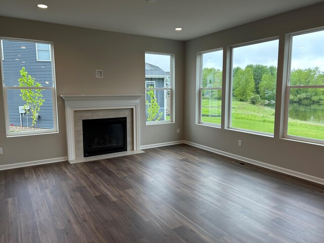 2924 Sheridan Cir Unit 57, Jackson, MI 49201 - unfurnished living room with dark wood finished floors, recessed lighting, and a tiled fireplace