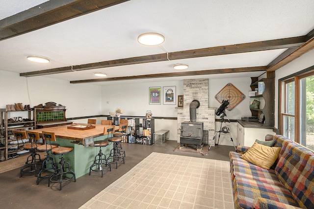 3274 E Rivers Edge, Newaygo, MI 49337 - dining area featuring beam ceiling, concrete flooring, a wood stove, and recessed lighting