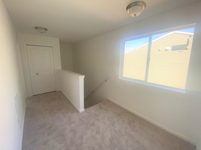 1050 Rebecca St Unit 18, Marshall, MI 49068 - unfurnished room featuring light carpet and baseboards