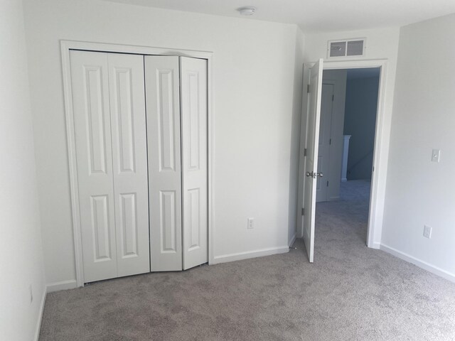 1050 Rebecca St Unit 18, Marshall, MI 49068 - unfurnished bedroom featuring carpet, a closet, and baseboards