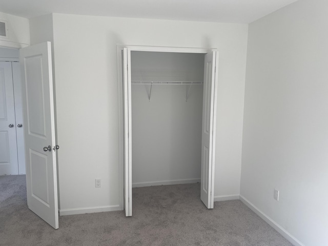 1050 Rebecca St Unit 18, Marshall, MI 49068 - unfurnished bedroom with carpet floors, a closet, and baseboards