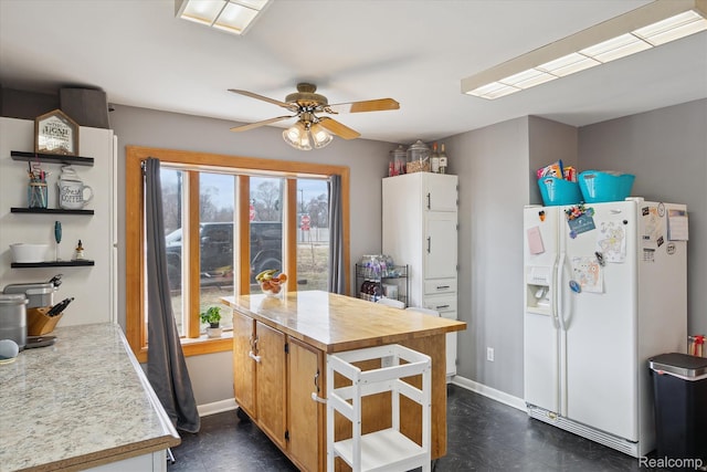 749 Gates Ave, Ypsilanti, MI 48198 - kitchen featuring white fridge with ice dispenser, open shelves, ceiling fan, and baseboards