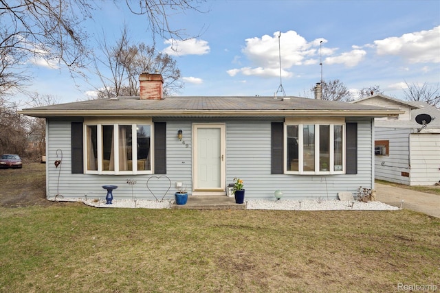 749 Gates Ave, Ypsilanti, MI 48198 - view of front of house featuring a chimney and a front lawn