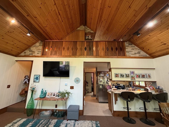 12480 Lone Wolf Trl, Canadian Lakes, MI 49346 - living area with wooden ceiling with exposed beams, rail lighting, wood walls, and high vaulted ceiling