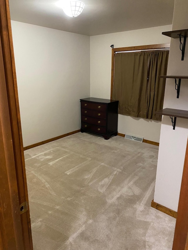 12480 Lone Wolf Trl, Canadian Lakes, MI 49346 - unfurnished bedroom featuring light carpet and baseboards