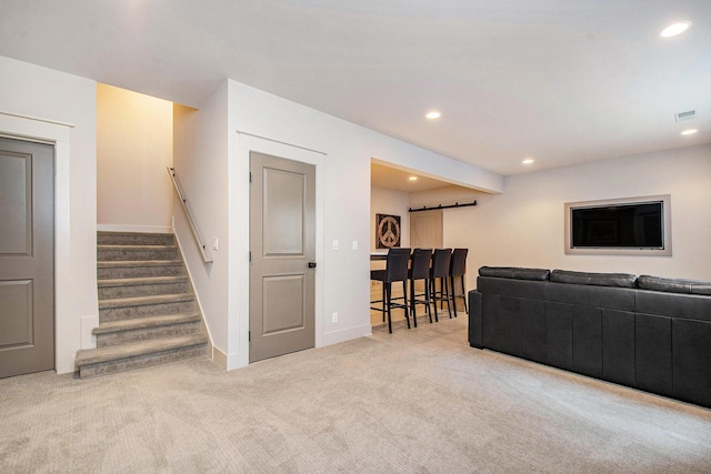 2234 Lake Dr SE, East Grand Rapids, MI 49506 - living area featuring carpet, recessed lighting, stairs, a barn door, and baseboards