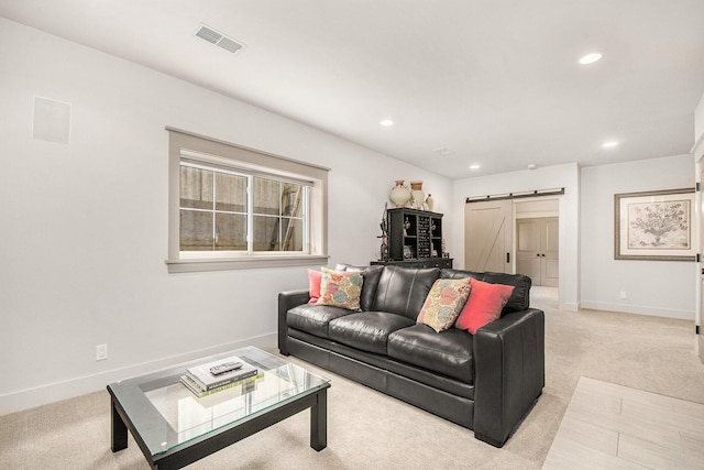 2234 Lake Dr SE, East Grand Rapids, MI 49506 - living area with a barn door, light colored carpet, recessed lighting, and baseboards