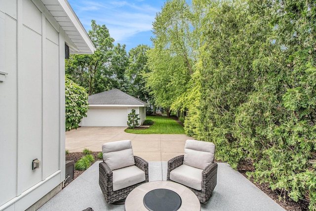 2234 Lake Dr SE, East Grand Rapids, MI 49506 - view of patio featuring an outbuilding, a detached garage, and view of wooded area