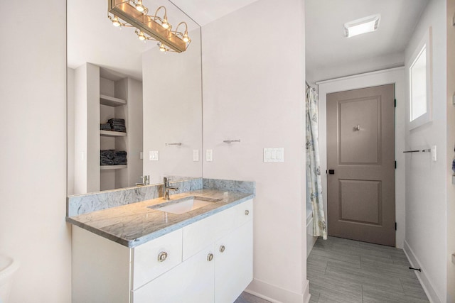 2234 Lake Dr SE, East Grand Rapids, MI 49506 - bathroom featuring baseboards, vanity, and curtained shower