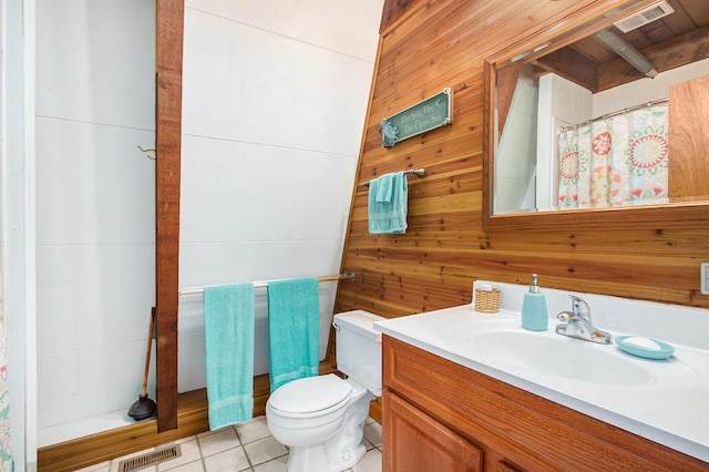 77125 Pinewood Ln, South Haven, MI 49090 - full bathroom with wooden walls, vanity, toilet, and tile patterned floors