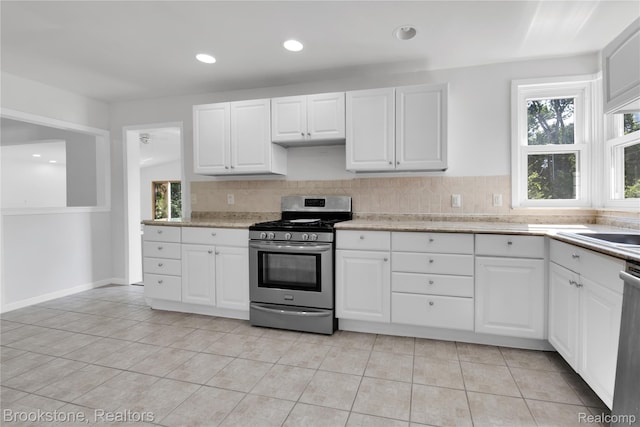 20930 Stahelin Rd, Southfield, MI 48075 - kitchen with stainless steel range with gas stovetop, light countertops, light tile patterned floors, decorative backsplash, and recessed lighting