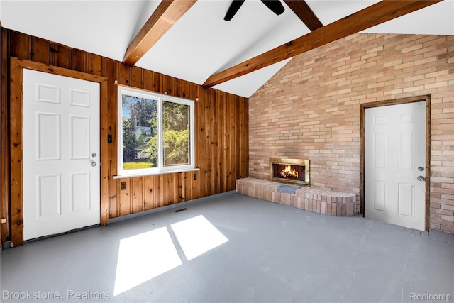 20930 Stahelin Rd, Southfield, MI 48075 - unfurnished living room with beam ceiling, a brick fireplace, high vaulted ceiling, ceiling fan, and wooden walls