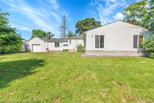 20930 Stahelin Rd, Southfield, MI 48075 - back of house with a lawn and an attached garage