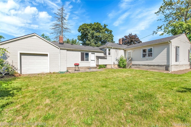20930 Stahelin Rd, Southfield, MI 48075 - rear view of property with a chimney, an attached garage, and a yard