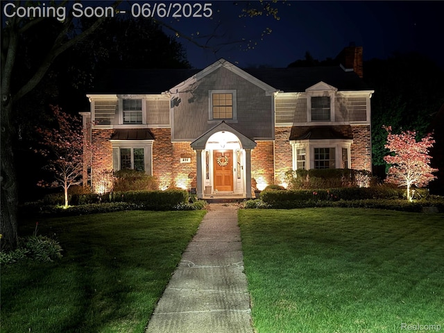 828 Westchester Rd, Grosse Pointe Park, MI 48230 - view of front facade with a lawn, a chimney, and stone siding