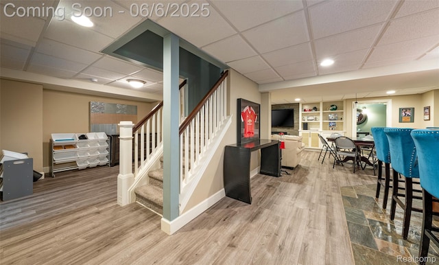 828 Westchester Rd, Grosse Pointe Park, MI 48230 - staircase with a paneled ceiling, baseboards, wood finished floors, built in shelves, and recessed lighting