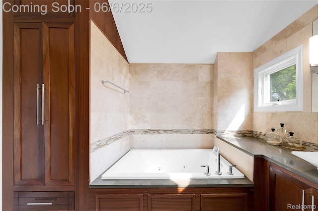 828 Westchester Rd, Grosse Pointe Park, MI 48230 - full bath with a tub with jets, vaulted ceiling, tile walls, and a sink