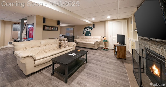 828 Westchester Rd, Grosse Pointe Park, MI 48230 - living room with a drop ceiling, wood finished floors, baseboards, a stone fireplace, and recessed lighting