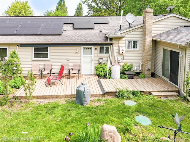 11305 Cook Rd, Gaines, MI 48436 - rear view of house featuring a lawn, a deck, and a shingled roof