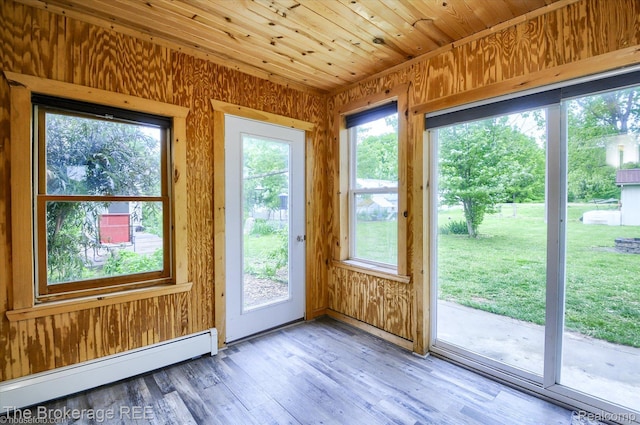 11305 Cook Rd, Gaines, MI 48436 - entryway with baseboard heating, wooden walls, and light wood-style flooring