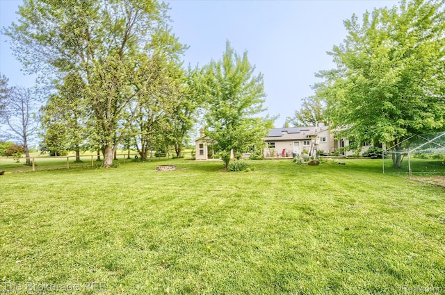 11305 Cook Rd, Gaines, MI 48436 - view of grassy yard with a fire pit