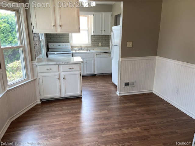 18980 Roscommon St, Grosse Pointe, MI 48225 - kitchen with white appliances, light countertops, white cabinetry, wainscoting, and plenty of natural light
