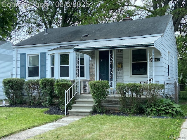 18980 Roscommon St, Grosse Pointe, MI 48225 - bungalow-style house with a chimney, a front yard, roof with shingles, and a porch