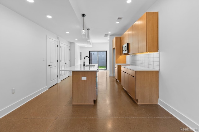 3420 Cochrane St Unit 2, Detroit, MI 48208 - kitchen featuring baseboards, light countertops, recessed lighting, a kitchen island with sink, and stainless steel microwave